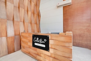 A reception desk with a sign that reads 'Collection Company-Serviced.'