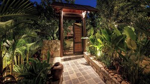 A wooden pergola structure with a tiled pathway leading to a glass door. - Lamia Tropical Garden (Tay Hoa Lu)