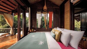 A room with a bed, a hanging light fixture, and a window with curtains. - Lamia Tropical Garden (Tay Hoa Lu)