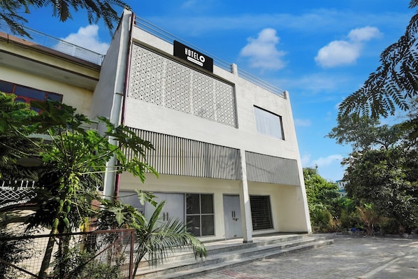 A modern hotel building with a sign reading 'HOTEL' and a geometric facade.
