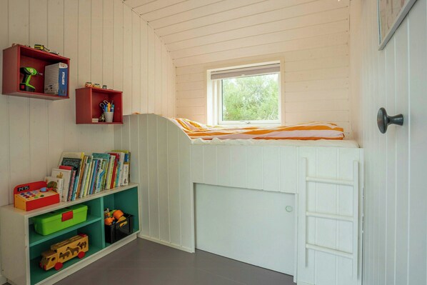 A child's room with a bunk bed, a bookshelf, and a window. - Architect-designed home with a maritime look (Sjællands Odde)