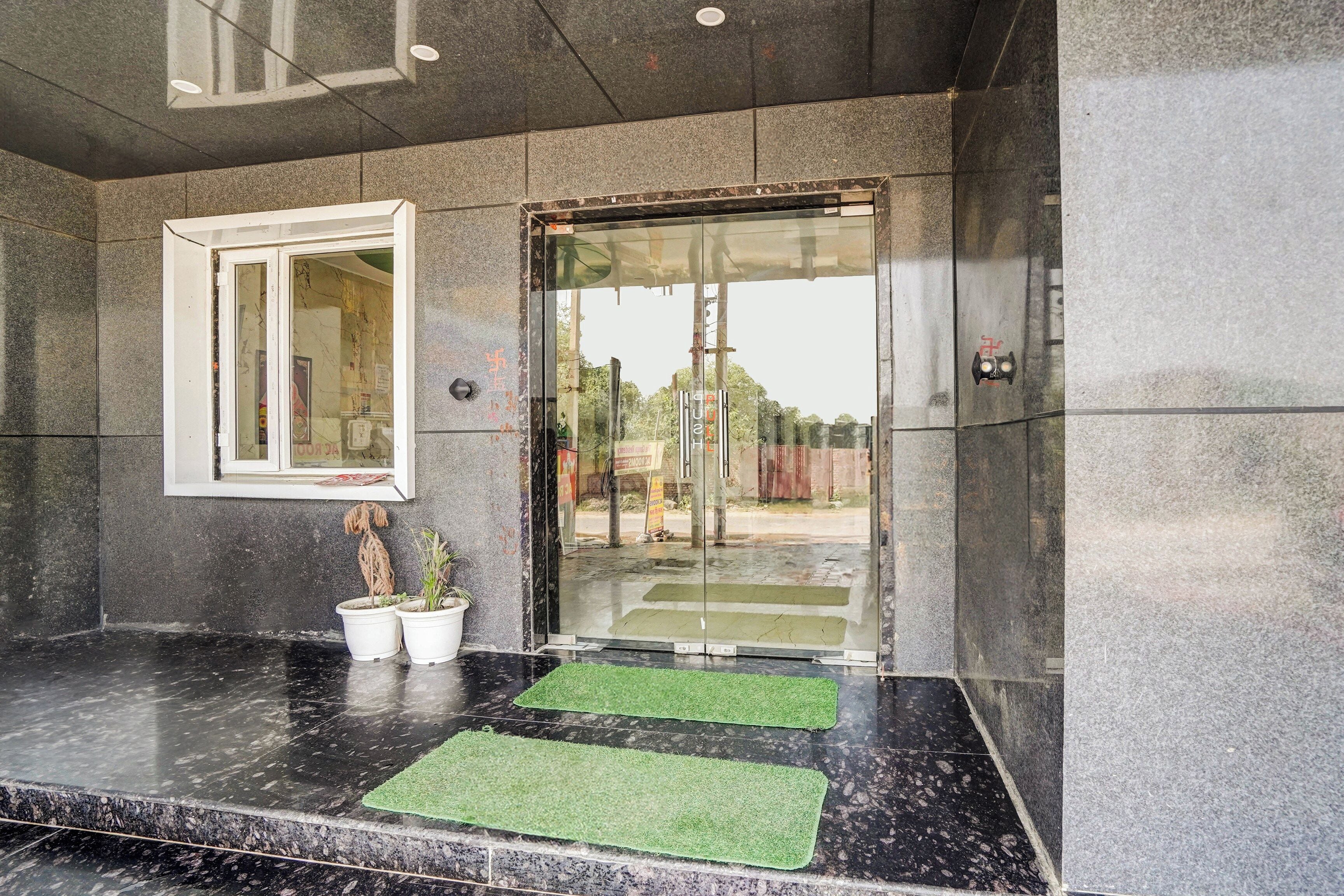 A reception area with a marble counter, a window, and a door with glass panels.