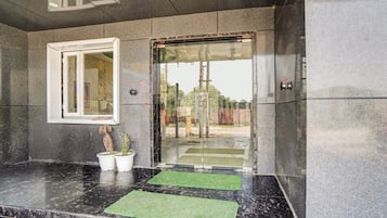 A reception area with a marble counter, a window, and a door with glass panels.