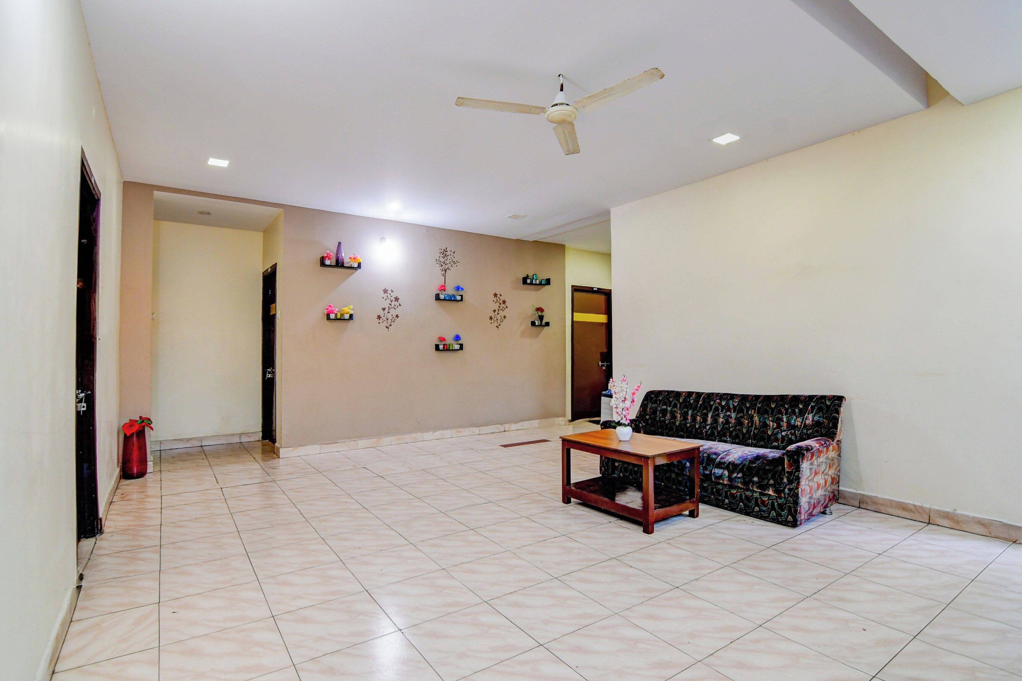 A spacious living area with a sofa, a coffee table, and a ceiling fan.