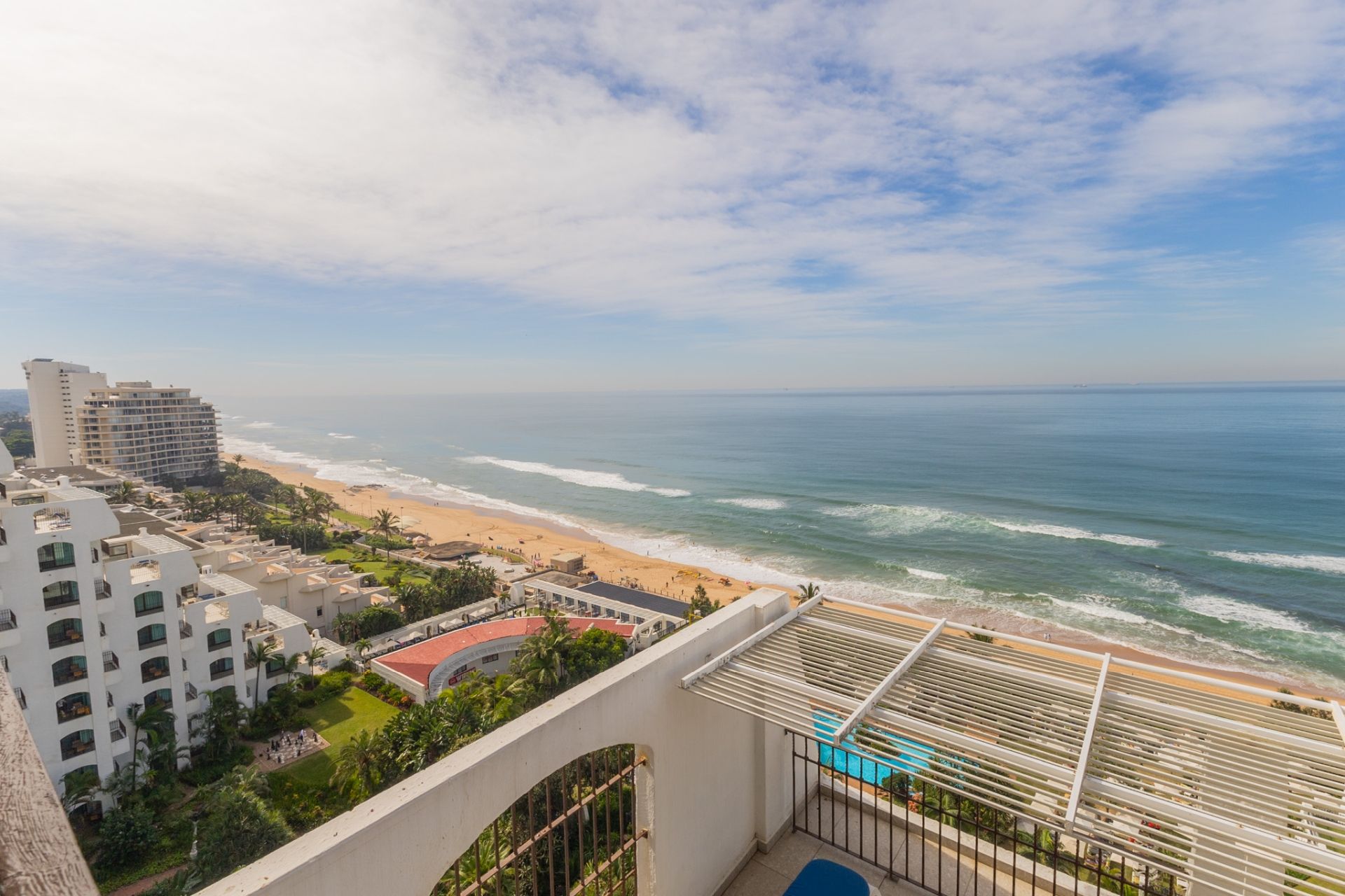 A coastal hotel with a view of the beach and ocean.