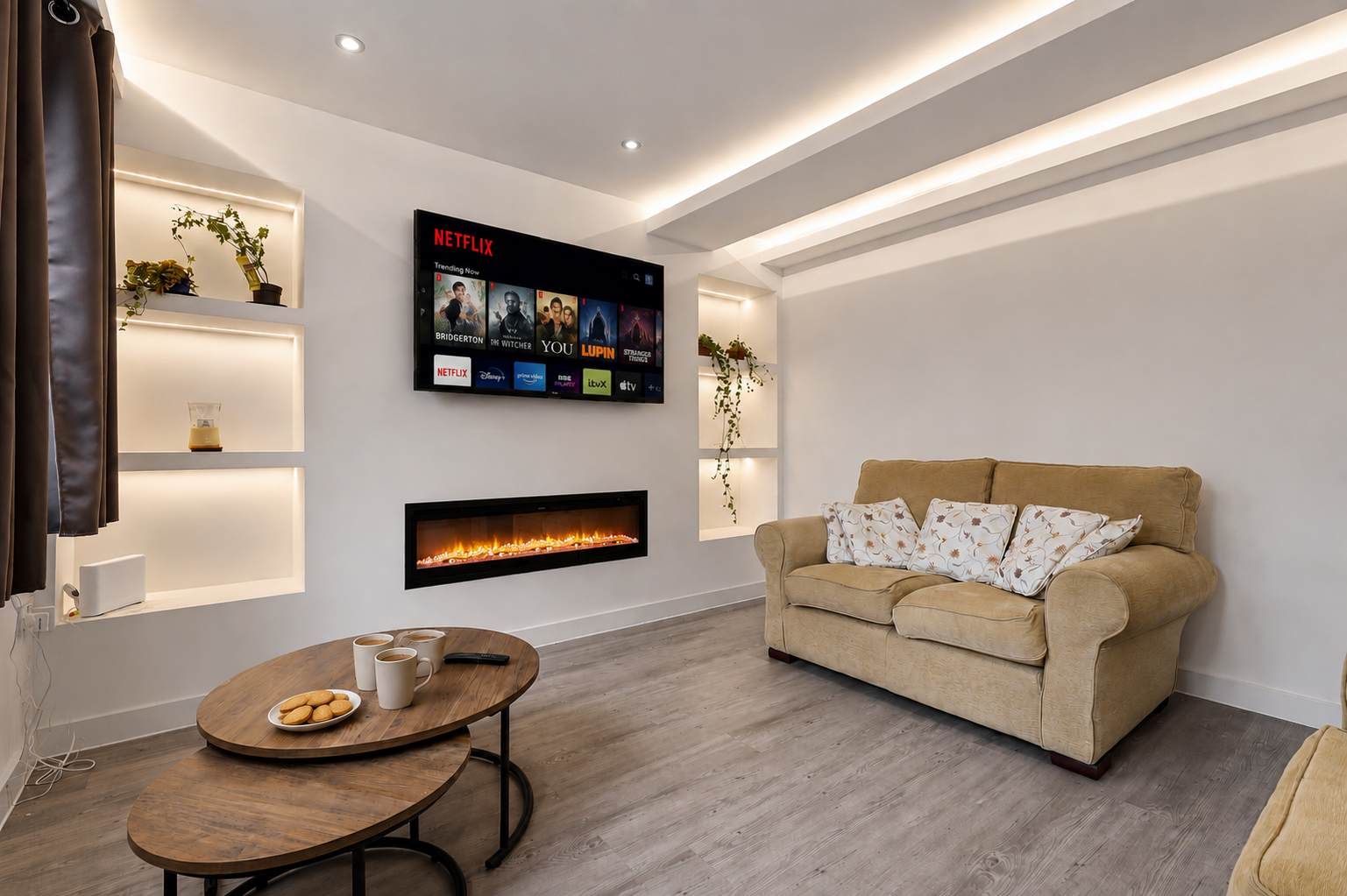 A modern living room with a fireplace, a sofa, a coffee table, and a wall-mounted TV displaying Netflix content.