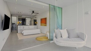 A modern bedroom with a bed, a hanging chair, and a bathroom visible through a glass door. - Exclusive 3-Bed Villa in Amphoe Ko Samui, Sleeps 6, 1020 (Chang Wat Surat Thani)
