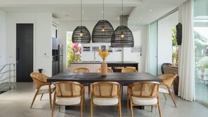 A modern dining area with a dark wooden table, six wicker chairs, and three hanging pendant lights. - Idyllic 4-Bed Villa in Amphoe Ko Samui, Sleeps 8, 1019 (Chang Wat Surat Thani)