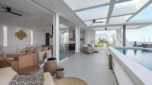 A modern interior with a pool, seating area, and a view of the outdoors. - Idyllic 4-Bed Villa in Amphoe Ko Samui, Sleeps 8, 1019 (Chang Wat Surat Thani)