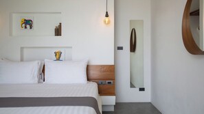 A bedroom with a bed, bedside table, wall-mounted light, and artwork. - Tranquil Escape in Koh Samui, Koh Samui Villa 1021 (Koh Samui)