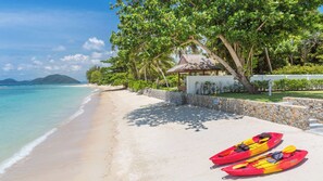 A beach with kayaks, a gazebo, and a clear view of the ocean. - Tranquil Escape in Koh Samui, Koh Samui Villa 1021 (Koh Samui)