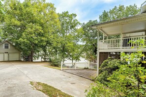 A two-story house with a covered porch and a garage. - Weiss Lake Group Retreat w/ Hot Tub & Fire Pit (Cedar Bluff)
