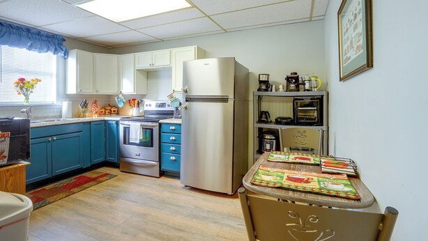 A kitchen with a refrigerator, stove, oven, and coffee maker.