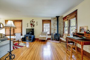 A living room with a fireplace, a television, and a dining area. - Near Lake Erie Beaches! Angola Gem w/ Patios (Angola)