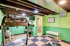 A room with a control panel, a bench, a wall-mounted television, and a motivational quote. - Near Lake Erie Beaches! Angola Gem w/ Patios (Angola)