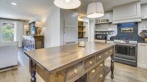 A kitchen with a central island, built-in appliances, and pendant lighting. - Mtn Views, On the White River: Norfork Getaway (Norfork)