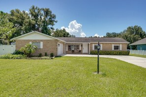 A single-story brick house with a front porch, a garage, and a well-maintained lawn. - Families w/ Pets Welcome! Retreat 14 Mi to Tampa (Brandon)