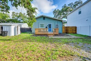 A single-story house with a front porch, a fenced yard, and a small shed. - South Tampa Stay w/ Backyard & Fire Pit! (Tampa)
