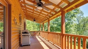 A wooden deck with a ceiling fan, a grill, and a view of a forest. - 4 Mi to Cherokee Lake! Wooded Escape Near Hiking (Murphy)