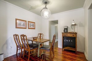A dining area with a wooden table and chairs, a coffee maker, and framed pictures on the wall. - East Memphis Duplex Near Midtown & Downtown (Memphis)
