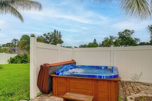 A hot tub in a backyard with a wooden deck and a white fence. - Hot Tub, Water View! Largo Home 10 Mi to Beaches (Largo)