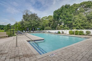A rectangular swimming pool with a tiled edge and a blue border, surrounded by a brick deck. - 1 Mi to Beach! Golfers Paradise on Pawleys Island (Pawleys Island)