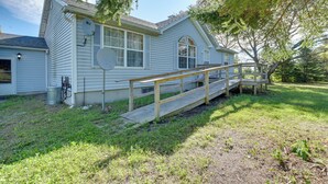A single-story house with a wooden deck and a ramp leading to the front door.