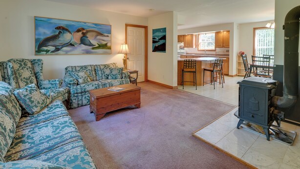 A living room with patterned sofas, a coffee table, and artwork on the walls.