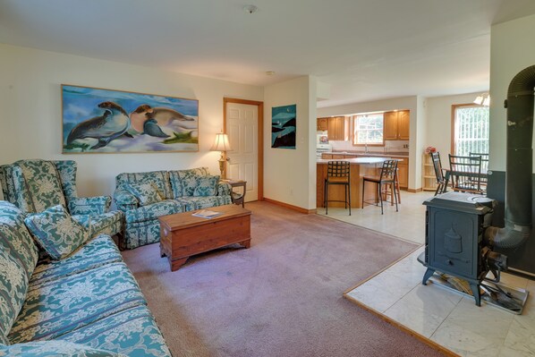 A living room with patterned sofas, a coffee table, and artwork on the walls. - 21 Acres, Near Trails to Shore With Island Access (Lubec)