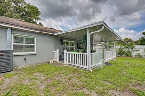 A residential house with a covered porch, a fenced yard, and a clear sky. - Families w/ Pets! Home 10 Mi to Busch Gardens (Tampa)