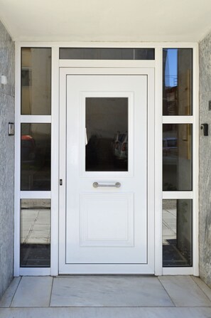 A white door with a handle and a rectangular window.