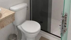 Kylpyhuone, jossa on wc, suihkukaappi ja pesuallas.