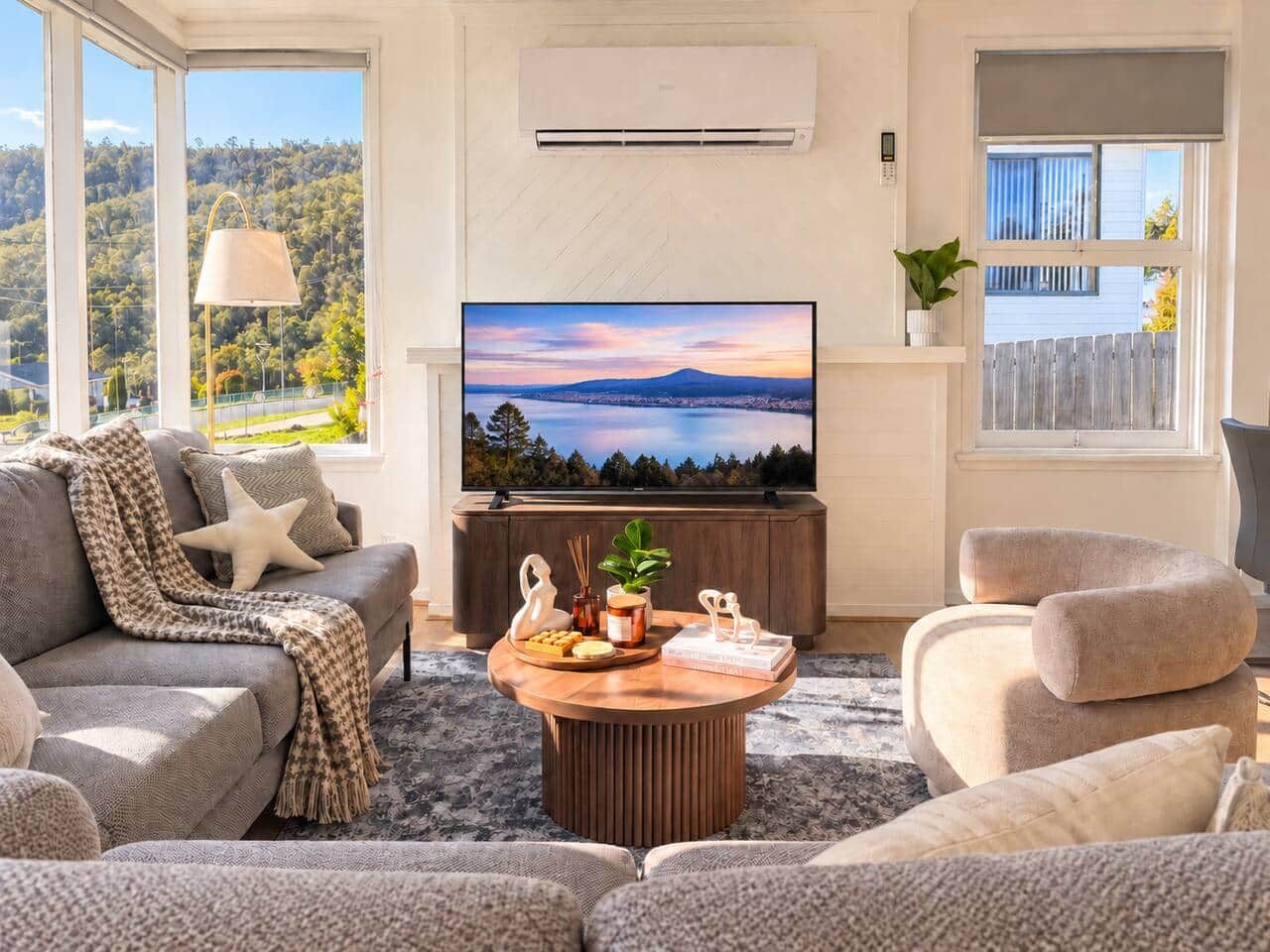 Bright Mornington living room with Smart TV, comfortable seating and sunny mountain outlook.
