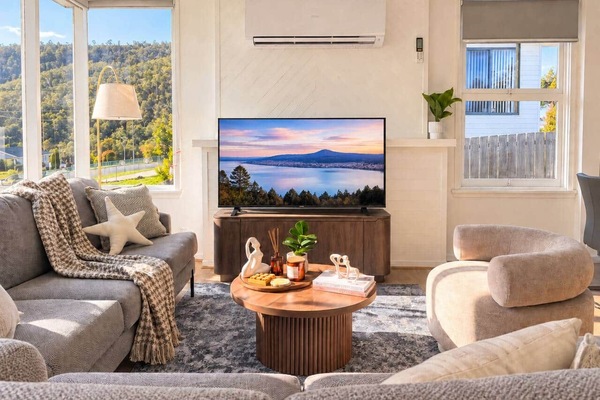 Bright Mornington living room with Smart TV, comfortable seating and sunny mountain outlook.