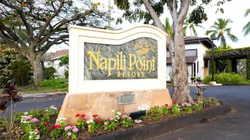 A sign for Napoli Point Resort with a stone base and a marble top.