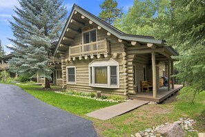 A log cabin with a balcony, a covered porch, and a well-maintained lawn. - Log Cabin Mountain Retreat in West Vail TCB10 (Vail)