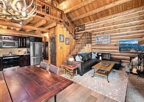 A log cabin interior with a dining area, kitchen, and living room. - Log Cabin Mountain Retreat in West Vail TCB10 (Vail)