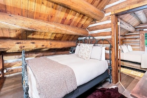 A log cabin bedroom with a bed, pillows, and a wooden headboard. - Log Cabin Mountain Retreat in West Vail TCB10 (Vail)