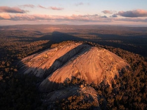 A mountainous landscape with a prominent rock formation.