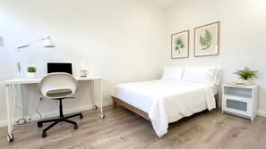 A bedroom with a bed, desk, chair, lamp, and two framed botanical prints on the wall. - Private Entrance Mini Studio S/AC/Laundry/Wifi (El Monte)