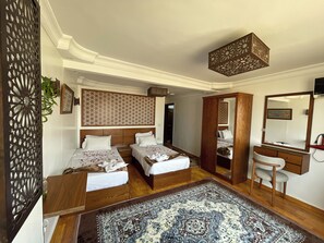 A hotel room with two beds, a wooden wardrobe, a mirror, and a patterned rug. - Oscar Pyramids view (Giza)