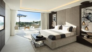 A modern bedroom with a large bed, a seating area with a view, and a balcony. - Vrbo Property (Marbella)