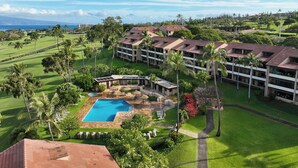A resort with a swimming pool, lush greenery, and a view of the ocean. - Kaanapali Royal | 3 Ocean View Villas, Sleeps 17 | Car Incl. w/ 6+ Nights | ML-4688 by KBM (Lahaina)