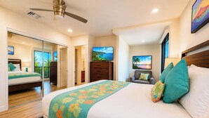 A hotel room with a bed, a television, a desk, and a chair. - Kaanapali Royal | 3 Ocean View Villas, Sleeps 17 | Car Incl. w/ 6+ Nights | ML-4688 by KBM (Lahaina)