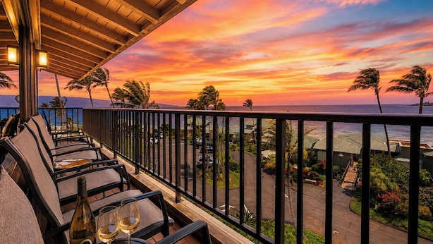 A terrace with outdoor seating and a view of the ocean at sunset. - Kapalua Bay Villas | 2 Oceanfront Villas, Sleeps 12 | Car Incl. w/ 6+ Nights | ML-4691 by KBM (Lahaina)