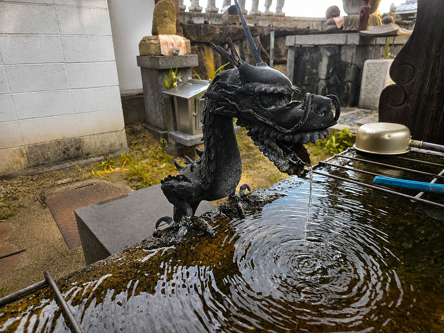 A water feature with a dragon sculpture.