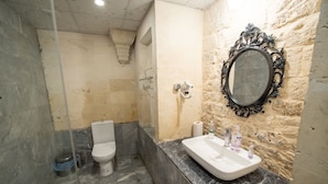 A bathroom with a marble sink, a toilet, and a mirror with an ornate frame. - Casa Blanca otel (Şanlıurfa)