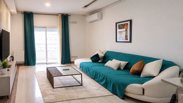 A modern living room with a sofa, coffee table, and a TV. - Elegant High-End Apartment (Tunis Governorate)