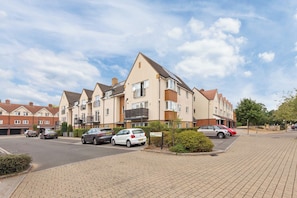 A residential street with terraced houses, a paved driveway, and parked cars. - Welcome to our  2-bedroom apartment in "Hayes, West London" perfect for up to 4–5 guests. Ideal for families, business travelers, couples and small groups. (Greater London)