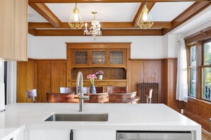 A kitchen with wooden cabinets, a white countertop, and a built-in stove. - Charming 2BR Jericho Home | Private Deck with BBQ! (Vancouver)
